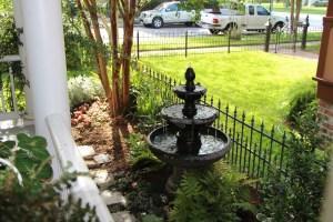 Our fountain right off the porch, so you can swing, watch the world go by and relax!
