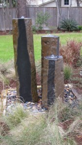 A trio of fountains made out of rock. 