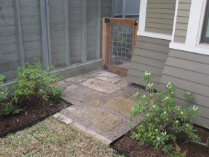We built a gate to keep the puppies in the back yard and entended the path out into the front garden because it often became a mud pit. 