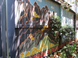 I love the contrast of the dark brown with the orange green and blue that is then reflected in the pots and plants.