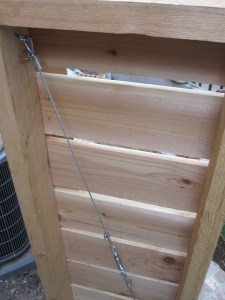 Cedar gate and A/C surround. Designed and constructed by Ravenscourt Landscaping & Design LLC