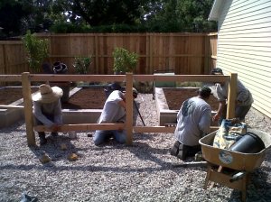 Constructing cedar and welded wire fence.