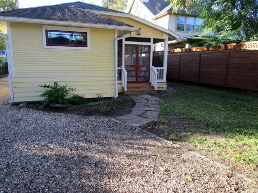 Before shot looking to house from garage.
