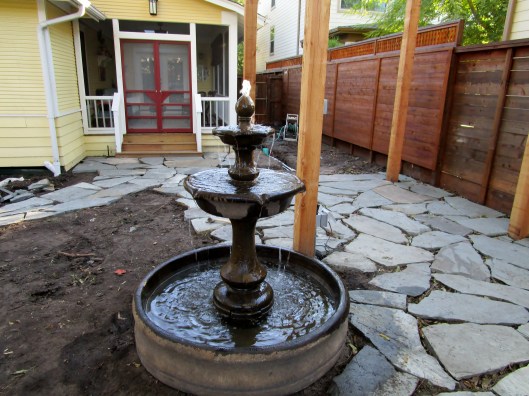 Fountain nestled into patio.
