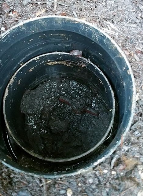 Note the handle (red, but covered in mud). It is in line with the pipe (thus open).