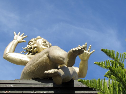 Happiness” is an 8-foot-tall gold-leaf nude that greets Laguna Nursery’s shoppers. She's perched on the roof of the shop, above the entrance on South Coast Highway. 