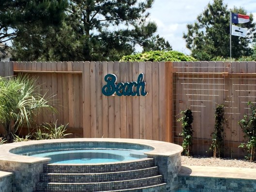 beach sign by pool 