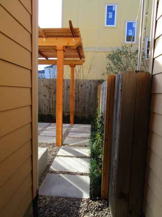 Peaking further into the back you can see the vines on the new welded wire we added to the fence and the rainbow gravel filled in between the pads. 